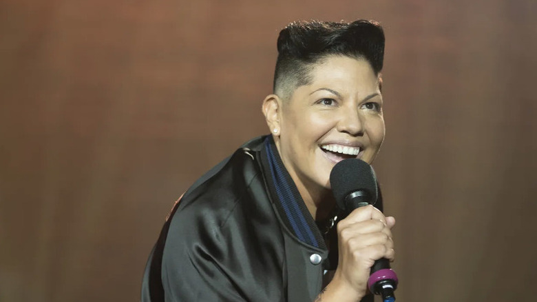 Sara Ramirez smiling with a microphone