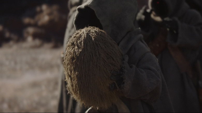 An off-world Jawa with a mudhorn egg in The Mandalorian