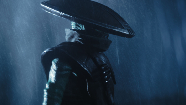 The bounty hunter Embo looking menacing in the rain in The Mandalorian and Grogu