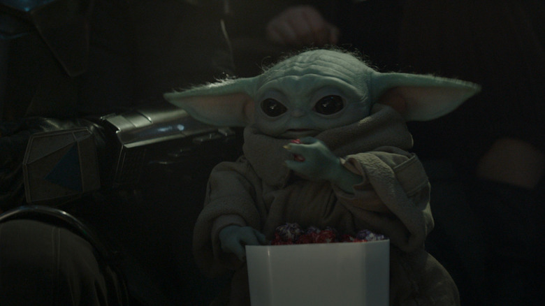 Grogu adorably eating some snacks in The Mandalorian and Grogu