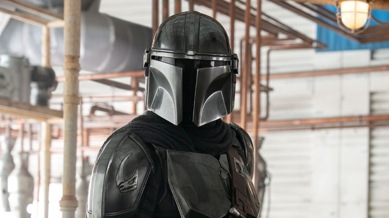 Din Djarin wearing his helmet and suit in The Mandalorian and Grogu