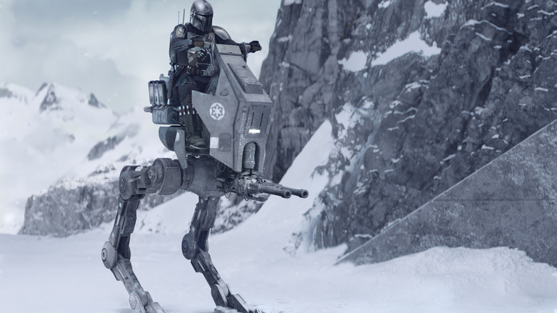 Pedro Pascal as Din Djarin wearing his armor and sitting atop an Imperial walker in the snow in Star Wars: The Mandalorian and Grogu