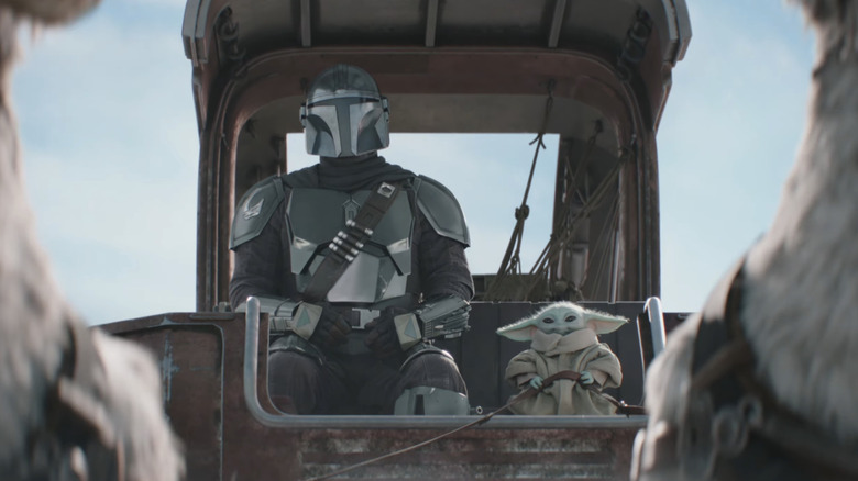 Mando and Grogu riding on a cart in The Mandalorian and Grogu Super Bowl Trailer