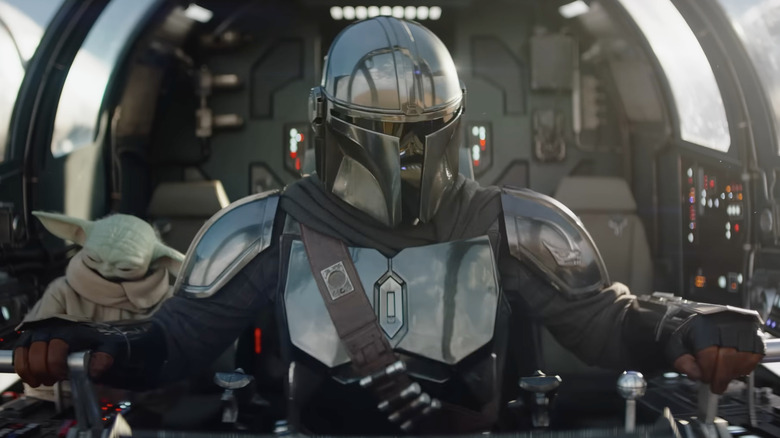 Din Djarin and Grogu prepare to take off in their spaceship in The Mandalorian and Grogu