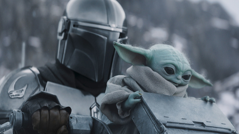 Din Djarin and Grogu riding on a speeder bike in The Mandalorian and Grogu
