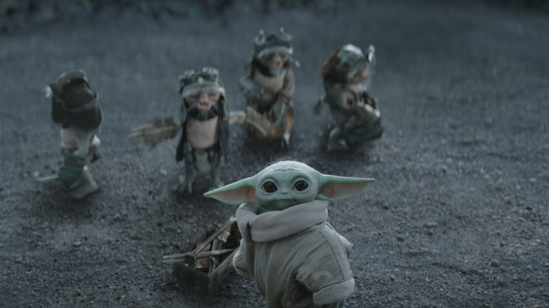 The Anzellans in the background with Grogu standing by a toolbox in The Mandalorian and Grogu