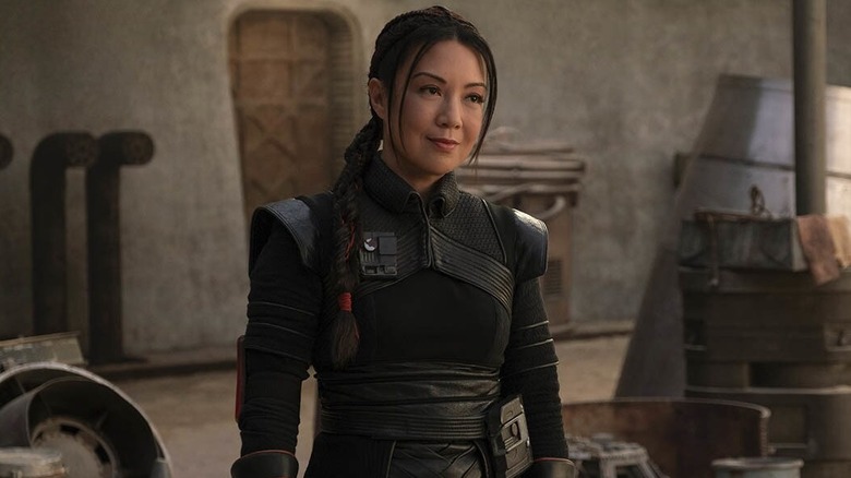 Ming-Na Wen as Fennec Shand standing in the streets of Tatooine in The Book of Boba Fett