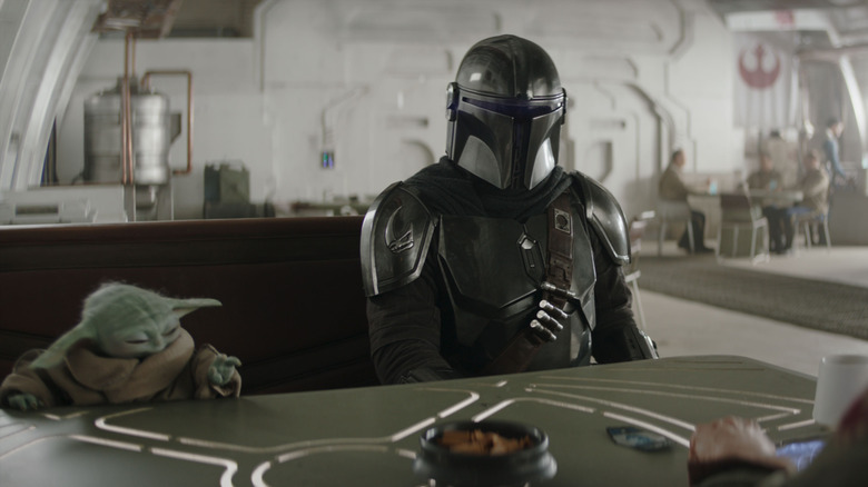 Grogu and Din Djarin sitting at a table in The Mandalorian and Grogu