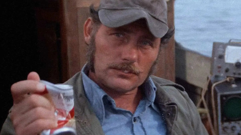 Robert Shaw crushes a can as Quint in Jaws