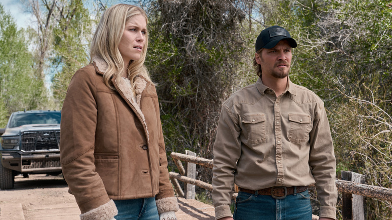 Ellyn Jameson's Dolly Weaver stands beside Luke Grimes' Kayce Dutton on a wooden bridge in Marshals
