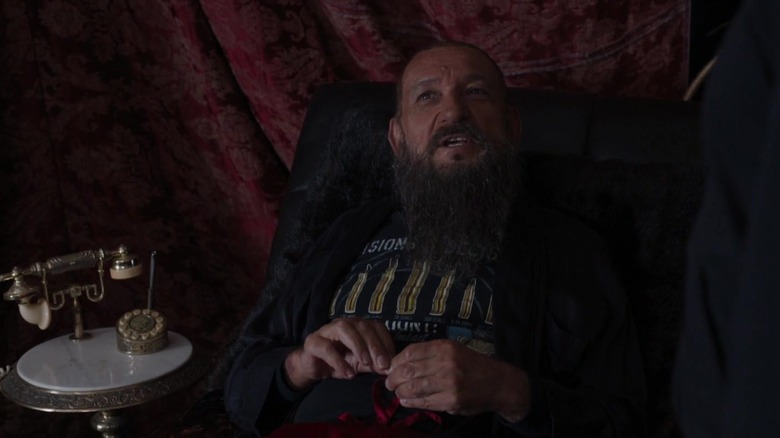 Trevor Slattery in a chair and a t-shirt in Iron Man 3