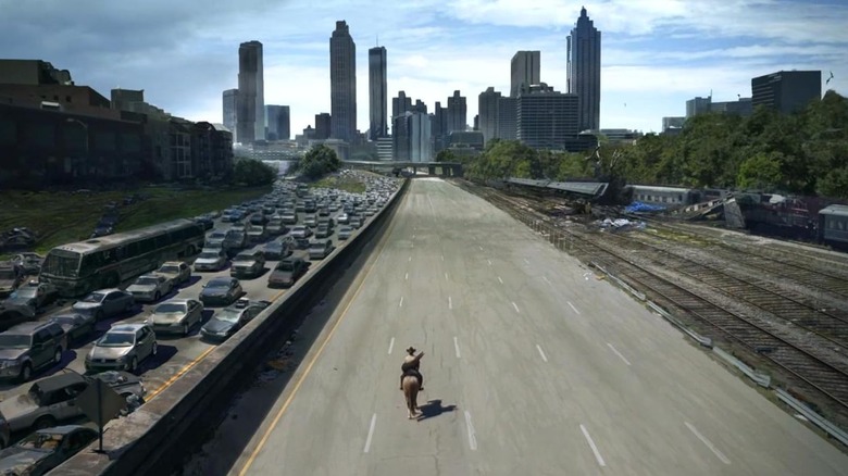 Rick on horseback traveling down an empty highway in The Walking Dead