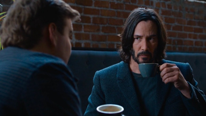 Neo drinks coffee with coworker