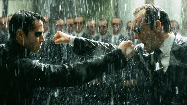 Neo fighting Agent Smith in front of a bunch of other Agent Smiths