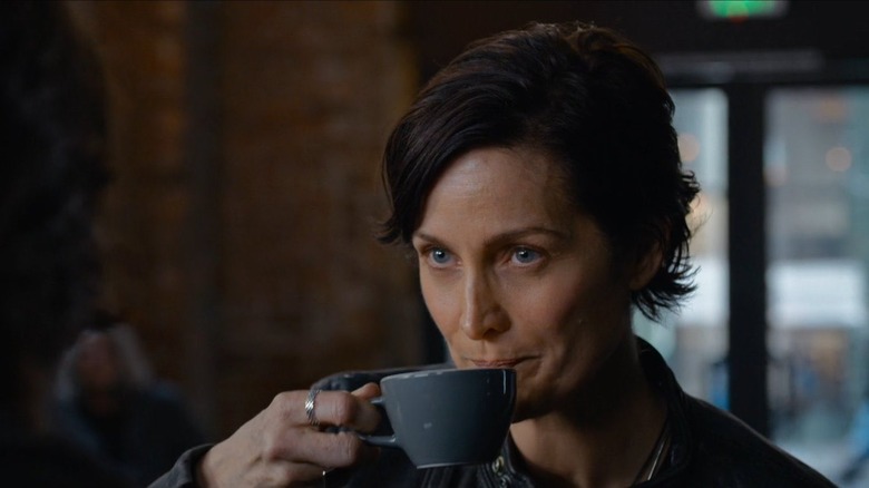 Trinity, thinking she's Tiffany, drinks coffee