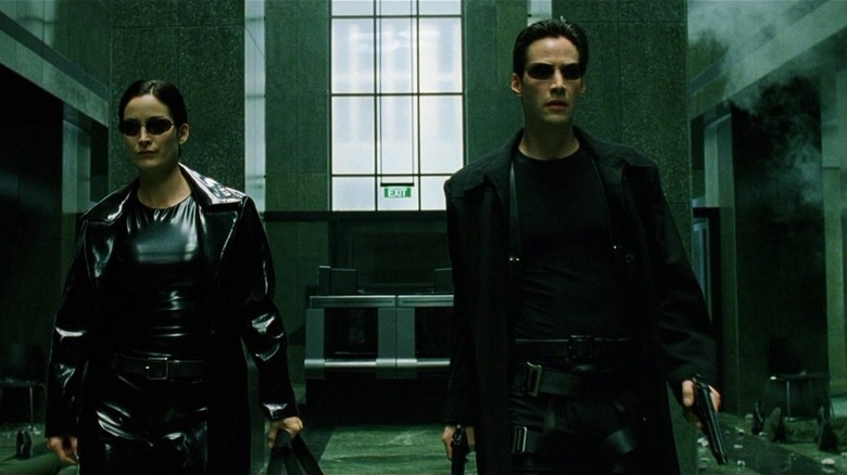 Trinity and Neo prepare to shoot a bunch of people in "The Matrix"