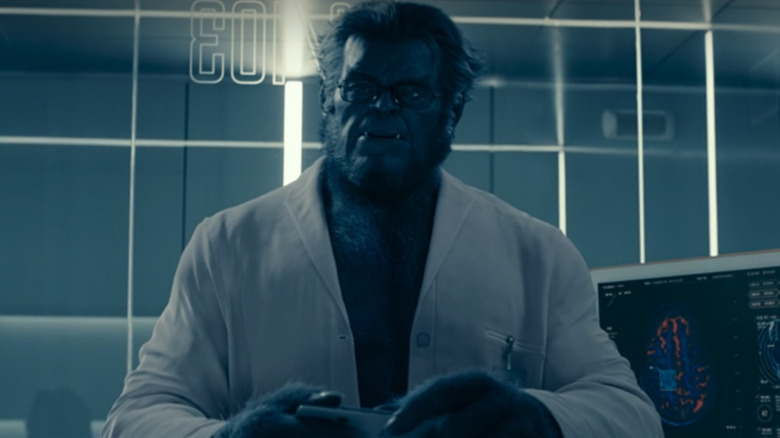 Kelsey Grammer as Dr. Hank McCoy/Beast standing in a lab in The Marvels