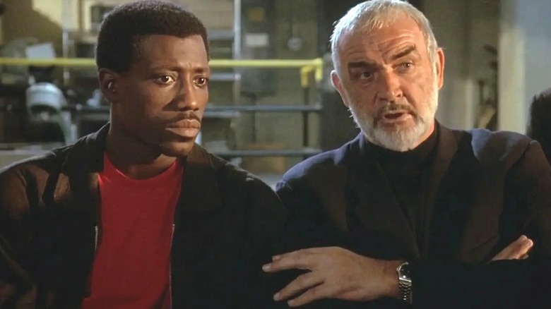 Web Smith and Captain Connor standing next to each other in Rising Sun