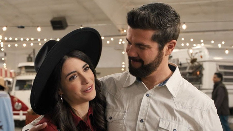 Beau Wirick as Jordan Moore holding Daniela Bobadilla as Dillon Michaels in The Happy Camper