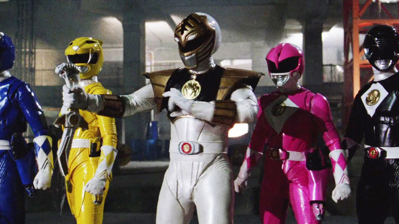 The white ranger stands in front of the Mighty Morphin Power Rangers in 