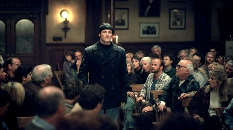 Andre Linoge appears and speaks during a town hall meeting in Storm of the Century