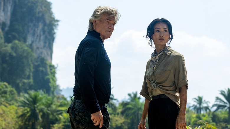 Kurt Russell as Lee Shaw standing in a jungle next to Mari Yamamoto as Keiko Randa in Monarch: Legacy of Monsters