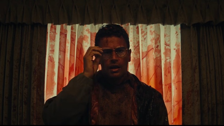 Theo James as Hal splattered in blood after a grisly death in The Monkey