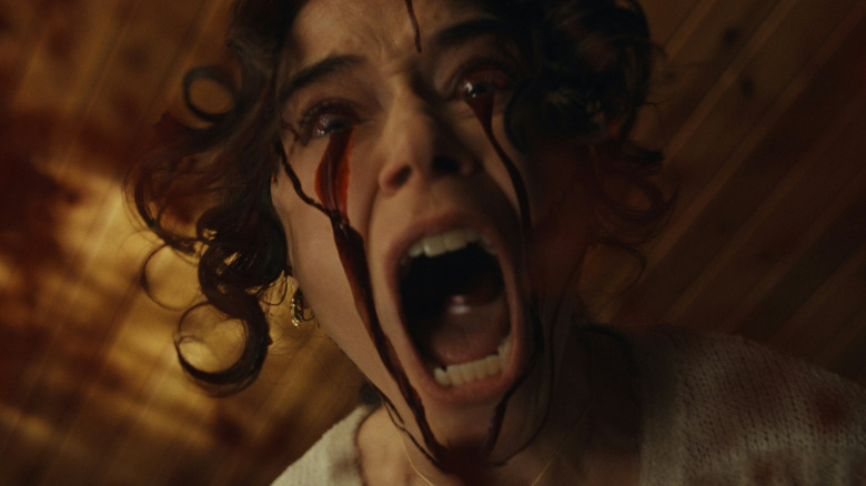 Tatiana Maslany as Lois screaming with blood coming out of her eyes in The Monkey