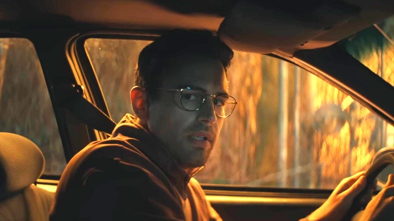 Hal in the car looking at the passenger seat