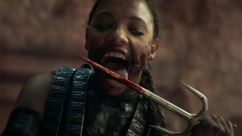 Mileena (Sisi Stringer) licks a bloody blade in Mortal Kombat (2021)