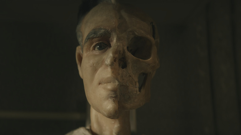 A burned mannequin face in The Mortician