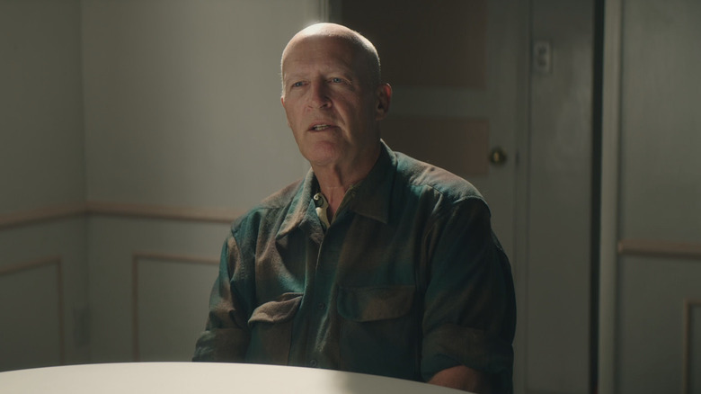 David Sconce sitting at a table, looking slightly off camera in The Mortician