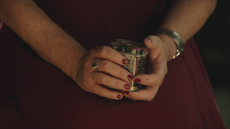 A woman holding what she thought were the remains of her loved one in The Mortician