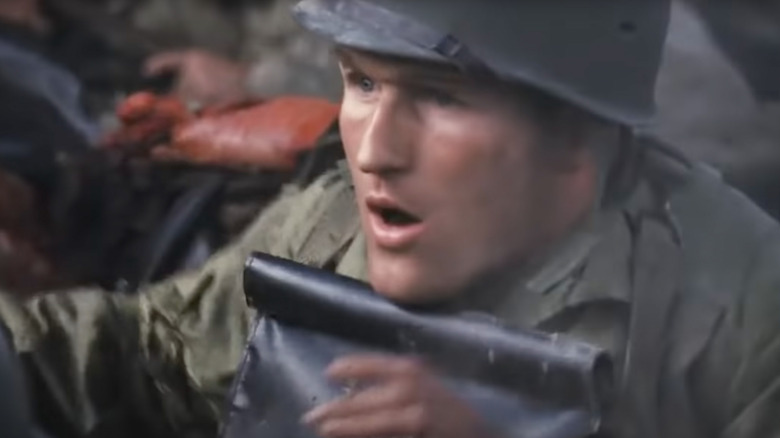 A soldier gets hit in the helmet