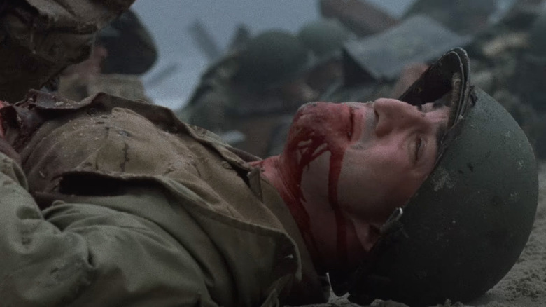 A man lies dying on the beach