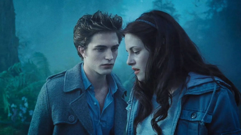 Edward and Bella in the woods whispering in Twilight
