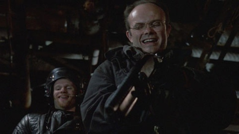 Boddicker aims his gun