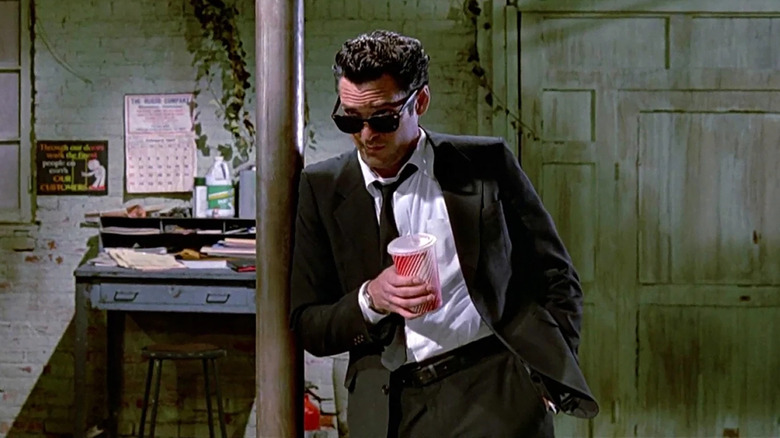 Mr. Blonde wearing sunglasses and holding a soda in Reservoir Dogs