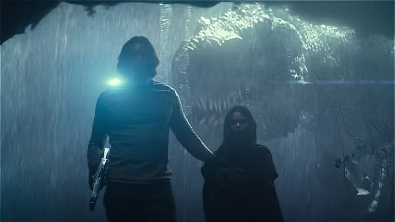 T-Rex appears behind Adam Driver and Arianna Greenblatt