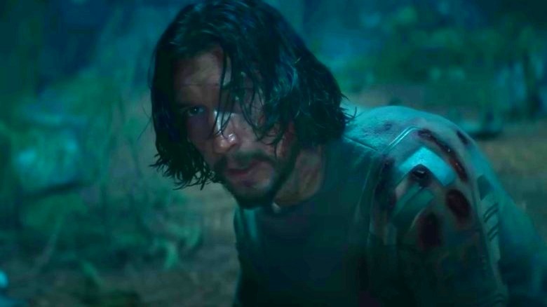 Adam Driver stares down a dinosaur