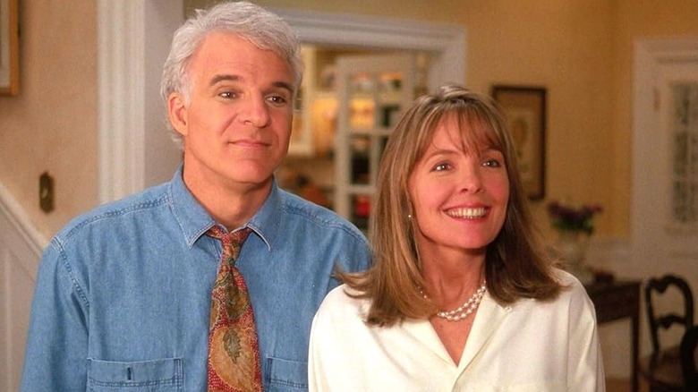 George and Nina smiling in their doorway in Father of the Bride