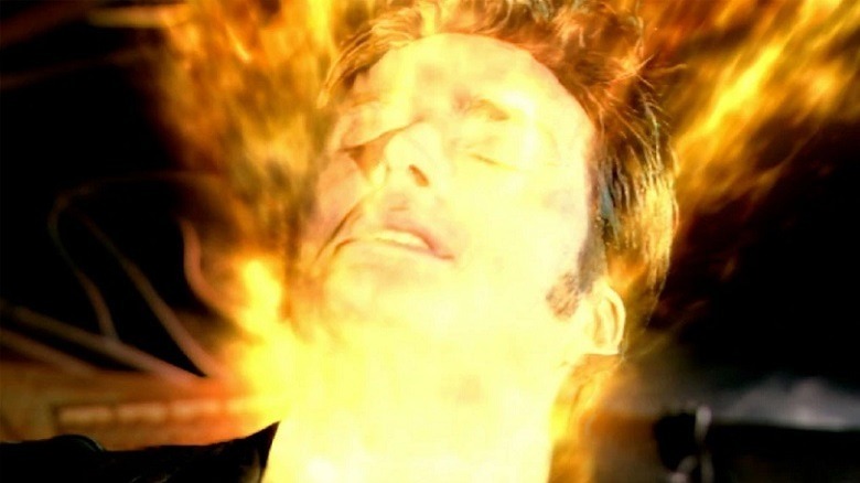 David Tennant's 10th Doctor, his face ablaze with yellow light