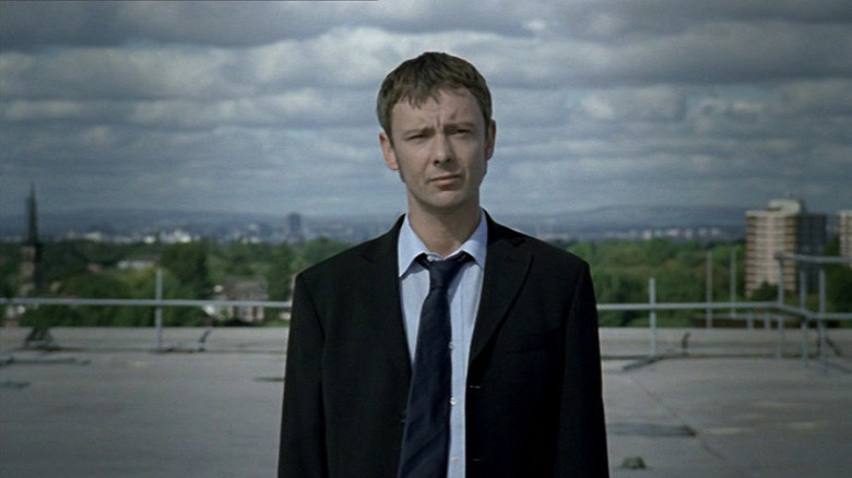 Sam Tyler stands on the roof of the police station