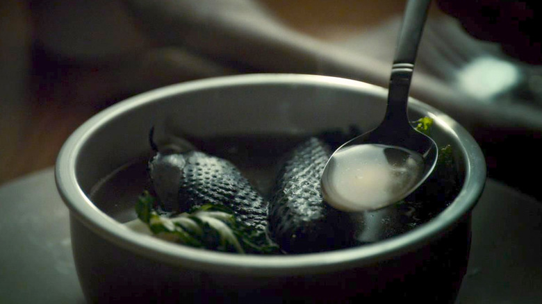 A bowl of black chicken soup