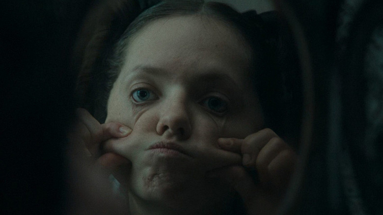 Elvira pinching her cheeks in The Ugly Stepsister