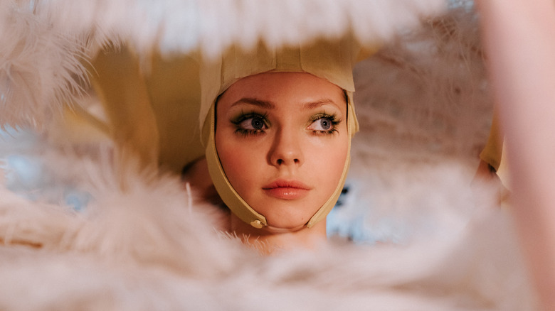 Elvira in the center of flowers in The Ugly Stepsister