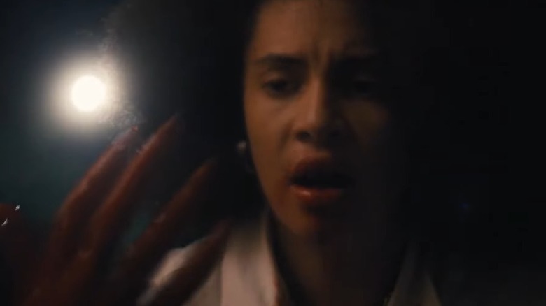 Jonny Baptiste looking at her own mutated hand in Perpetrator