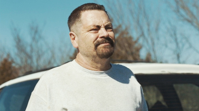 Nick Offerman's Jerry Kane stands next to a white car in Sovereign