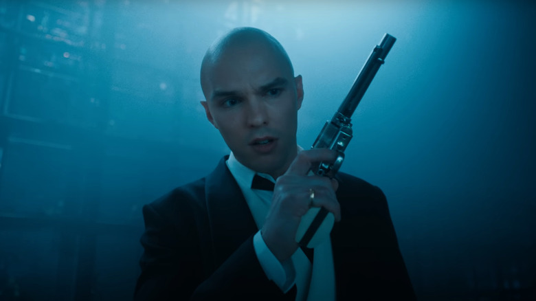 Lex Luthor holds a pistol in a dark room in Superman James Gunn's