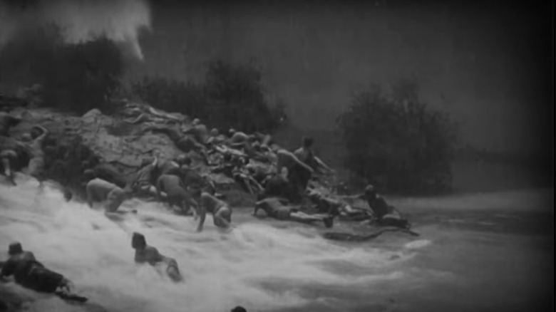 People escape a flood by climbing a hill in Noah's Ark